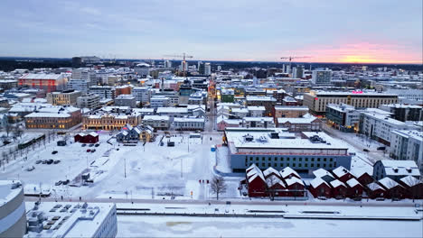 Aerial-view-over-the-market-square-and-streets-of-Oulu,-winter-dawn-in-Finland