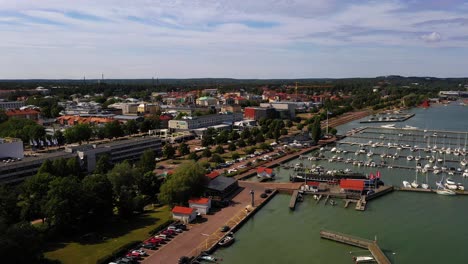 Aerial-view-of-the-harbor-in-Maarianhamina-city,-summer-in-Ahvenanmaa,-Finland---tracking,-drone-shot