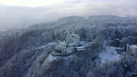 Drone-Shot-of-Hotel-Chateau-Gutsch-on-Hill-Above-Lucerne,-Switzerland-in-Late-Winter-Season