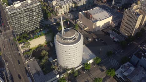 Drone-Shot-of-Famous-Capitol-Records-Building,-Hollywood-Landmark-on-Sunny-Evening,-Los-Angeles-CA-USA