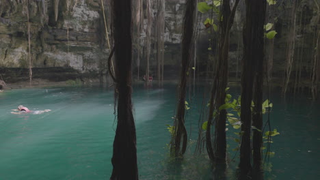 People-Swimming-in-Turquoise-Water-of-Mexican-Cenote,-San-Lorenzo-Oxman