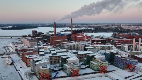 Aerial-view-around-the-Ruoholahti-area,-winter-sunset-in-Helsinki,-Finland---circling,-drone-shot