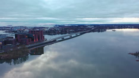 Aerial-drone-view-towards-the-Lapinlahti-bridge,-road-51,-cloudy-autumn-day,-in-Helsinki