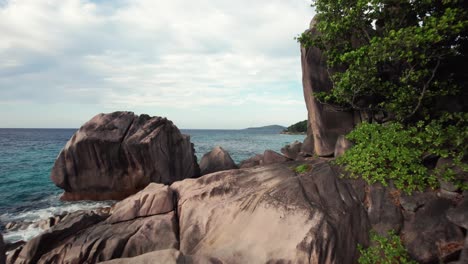 FPV-Drone-Close-to-Granite-Boulders-from-Pointe-Cap-Barbi-to-Anse-Severe,-La-Digue-Island,-Seychelles