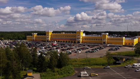 Aerial-view-of-the-Keskisen-kylakauppa-shopping-mall-and-hotel-in-Tuuri,-Finland---rising,-drone-shot