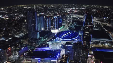 Los-Angeles-CA-USA-at-Night,-Aerial-View-of-Crypto-Arena,-Peacock-Theater-and-Towers-in-Lights