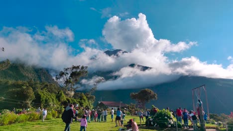 People-are-visiting-a-lookout-spot-called-el-Columpio-in-Baños,-Ecuador-which-is-in-front-of-Tungurahua-volcano