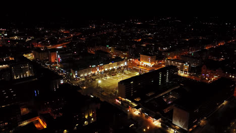 Aerial-view-rotating-toward-the-night-lit-market-square-of-Vaasa,-winter-in-Finland