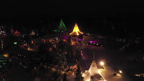 Aerial-View-of-Glowing-Dreamy-Colours-of-Santa-Claus-Village,-Finland,-Established-Shot