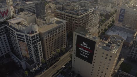 Drone-Shot-of-Hollywood-Boulevard,-Walk-of-Fame-and-Downtown-Buildings-at-Sunset