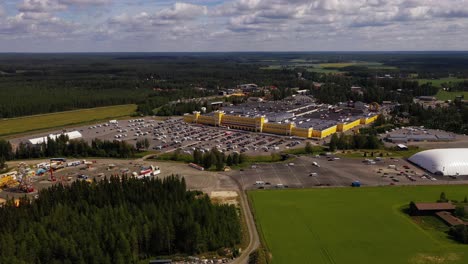 Aerial-view-around-the-Keskisen-kylakauppa-Department-Store-in-Tuuri,-Finland---wide,-circling,-drone-shot