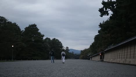 European-tourist-walking-in-the-imperial-palace-garde-in-Kyoto