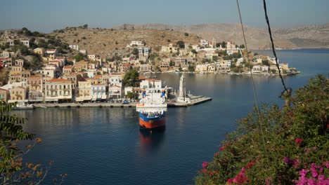 High-angle-view-on-the-colorful-harbor-of-Ano-Symi,-A-ferry-moored-waiting-for-departure