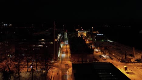 Aerial-view-over-illuminated-streets,-winter-night-in-Katajanokka,-Helsinki,-Finland