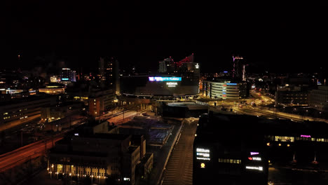 Panoramic-drone-shot-around-the-Nokia-arena,-winter-night-in-Tampere,-Finland