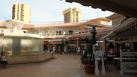 Decorative-outdoor-shopping-center-with-fountain-at-Playa-de-la-Americas