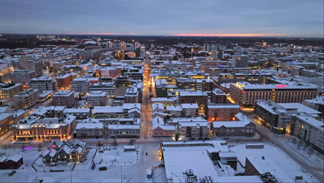 Drone-shot-over-the-skyline-of-Oulu,-winter-evening-in-Ostrobothnia,-Finland