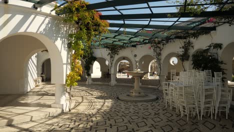 Picturesque-view-of-the-round-hall-at-Kallithea-Springs-with-open-roof-and-flower-on-the-walls