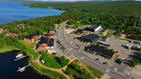 Aerial-view-circling-the-townscaper-of-Inari,-sunny,-summer-day-in-Lapland,-Finland