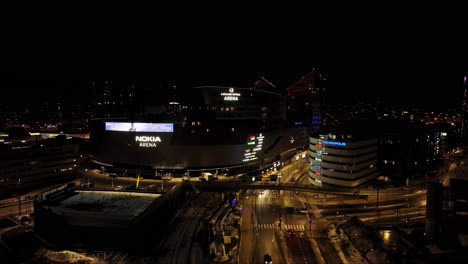 Nokia-arena-and-traffic-on-a-winter-night-in-Tampere,-Finland---Aerial-view
