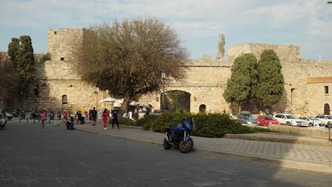 Busy-Street-With-People-And-Scooters-By-The-Gate-Of-Rodos-Town
