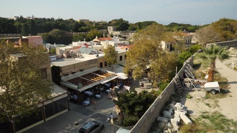 High-angle-view-on-the-walking-street-in-Rodos-Town,-Stone-walls-can-be-seen-in-the-background