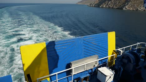 Back-part-of-a-ferryboat-with-greek-flag-and-its-shadow-waving