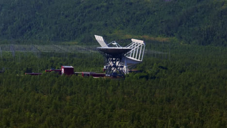 Telephoto-drone-shot-approaching-the-EISCAT-facility,-summer-day-in-Tromso,-Norway