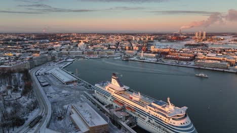 Aerial-view-around-the-South-Harbour-cityscape,-winter-evening-in-Helsinki,-Finland---circling,-drone-shot