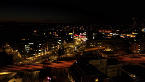 Aerial-view-around-traffic-on-thr-night-lit-streets-of-the-Ratina,-in-Tampere,-Finland