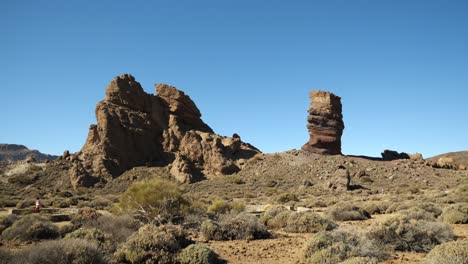 Tourists-walking-around-big-rock-formation-in-Teide-National-Park
