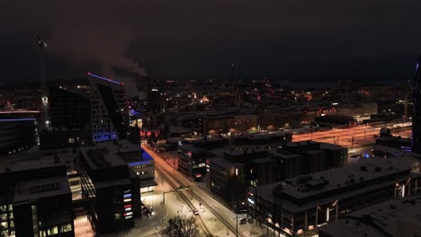 Overlooking-street-and-office-buildings-Tampere-city,-winter-evening-in-Pirkanmaa,-Finland---Aerial-view