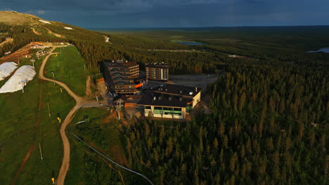 Aerial-view-around-the-Hotel-Levi-Panorama,-midnight-sun-with-dramatic-sky-in-Lapland,-Finland