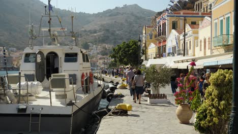 Many-tourists-walking-in-the-harbor-of-Symi-Island-after-the-arrival-of-the-ferry