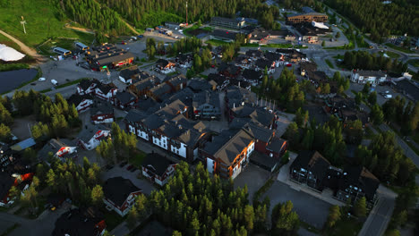 Aerial-view-tilting-towards-the-town-center-of-Levi,-summer-sunset-in-Lapland,-Finland