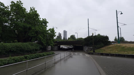 Vancouver-Suburbs-in-Rainy-Day,-Street-and-Pedestrian-Pathway-Under-Bridge