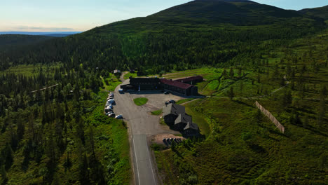Aerial-view-around-Lapland-hotel-Pallas,-sunny-summer-day-in-Finland---orbit,-drone-shot