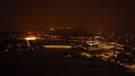 Establishing-drone-shot-of-the-coast-of-Oulu-city,-winter-night-in-Finland