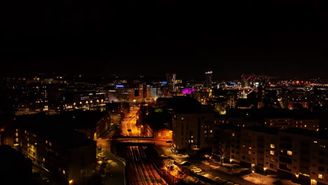 Drone-shot-approaching-downtown-Tampere,-winter-night-in-Pirkanmaa,-Finland