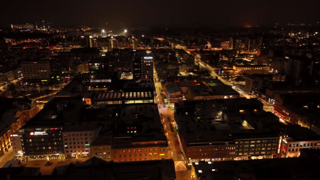Illuminated-city-streets-of-downtown-Oulu,-winter-night-in-Ostrobothnia,-Finland---Aerial-view