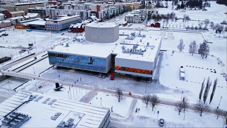 Aerial-view-descending-in-front-of-the-Oulu-Theatre,-winter-morning-in-Finland