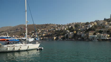The-harbour-of-Symi,-Many-houses-on-the-hill-and-castle-ruins-on-the-top