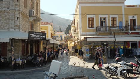 Tourists-on-the-shopping-street-of-the-colorful-Ano-Symi