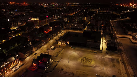 Aerial-view-approaching-the-Oulun-kauppahalli,-winter-evening-in-Oulu,-Finland