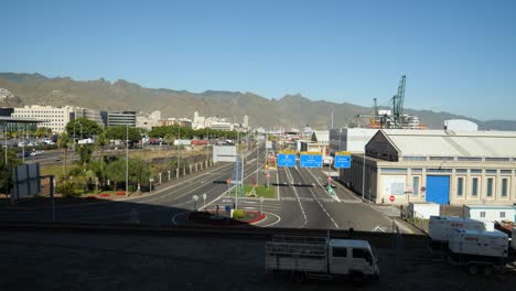 Empty-street-in-Santa-Cruz-de-Tenerife,-Hills-in-background,-Van-passes-by