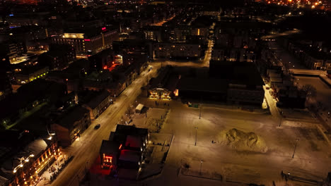 Aerial-view-tilting-away-from-the-Market-hall,-winter-evening-in-Oulu,-Finland