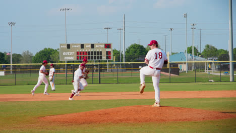 Baseball-Pitcher-Throws-Ball-During-Timeout-As-Teammates-Run-By-In-The-Background-Slow-Motion