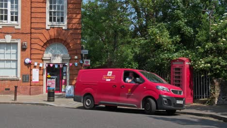 Post-Man-Drives-Red-Van-Outside-Blackheath-Village-Post-Office-in-Summer-Afternoon
