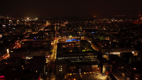 Cinematic-drone-overview-of-illuminated-streets-of-Oulu,-winter-night-in-Finland