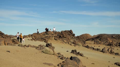 Tourists-on-the-rocks-in-Teide-National-Park,-Tenerife